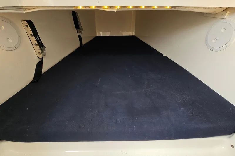 Redemption Yacht Photos Pics 2012 Regulator 34SS cabin interior with cushioned sleeping area and overhead lighting.