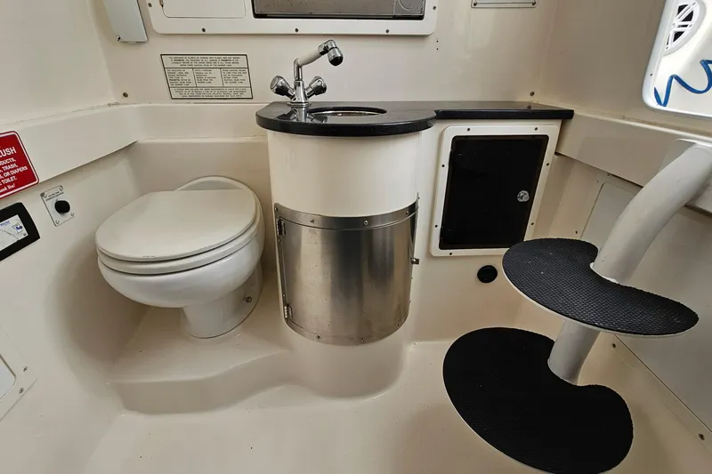 Redemption Yacht Photos Pics 2012 Regulator 34SS boat interior with toilet, sink, and spiral steps.