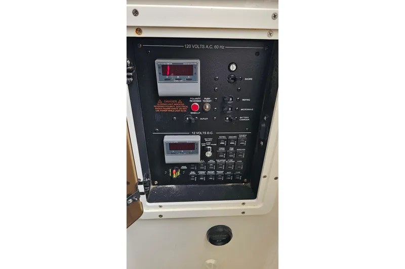 Redemption Yacht Photos Pics Electrical control panel on a 2012 Regulator 34SS boat, featuring voltage meters and switches.