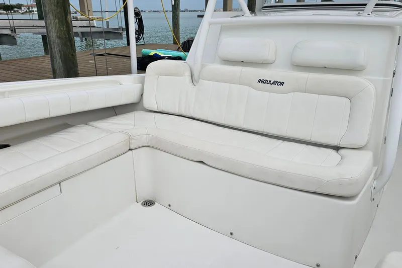 Redemption Yacht Photos Pics 2012 Regulator 34SS boat with white cushioned seating at the dock.