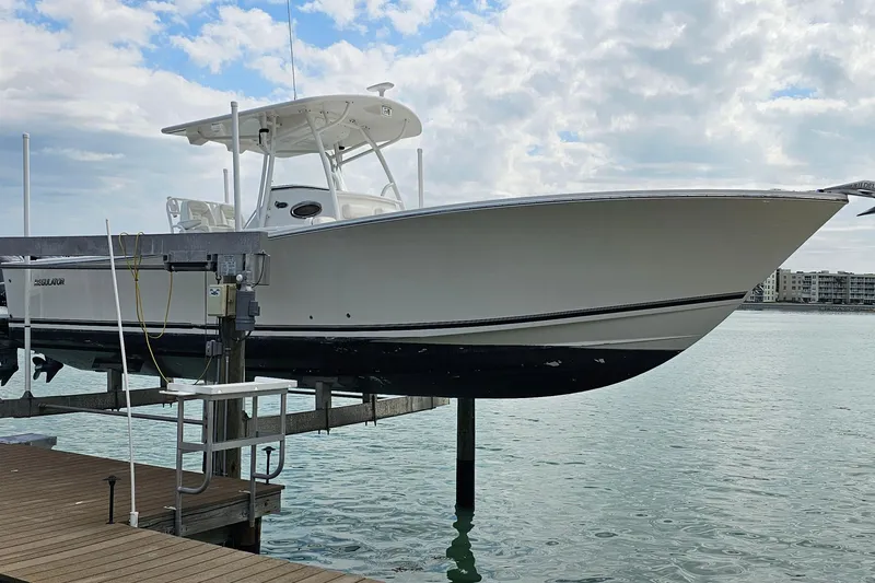 Redemption Yacht Photos Pics 2012 Regulator 34SS boat on lift by waterfront dock.