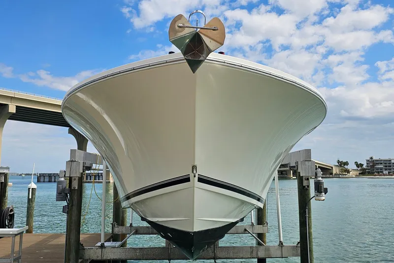 Redemption Yacht Photos Pics 2012 Regulator 34SS boat on lift, under blue sky near bridge.