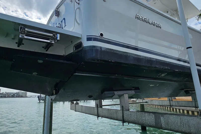 Redemption Yacht Photos Pics 2012 Regulator 34SS boat on lift, showcasing hull and stern details.