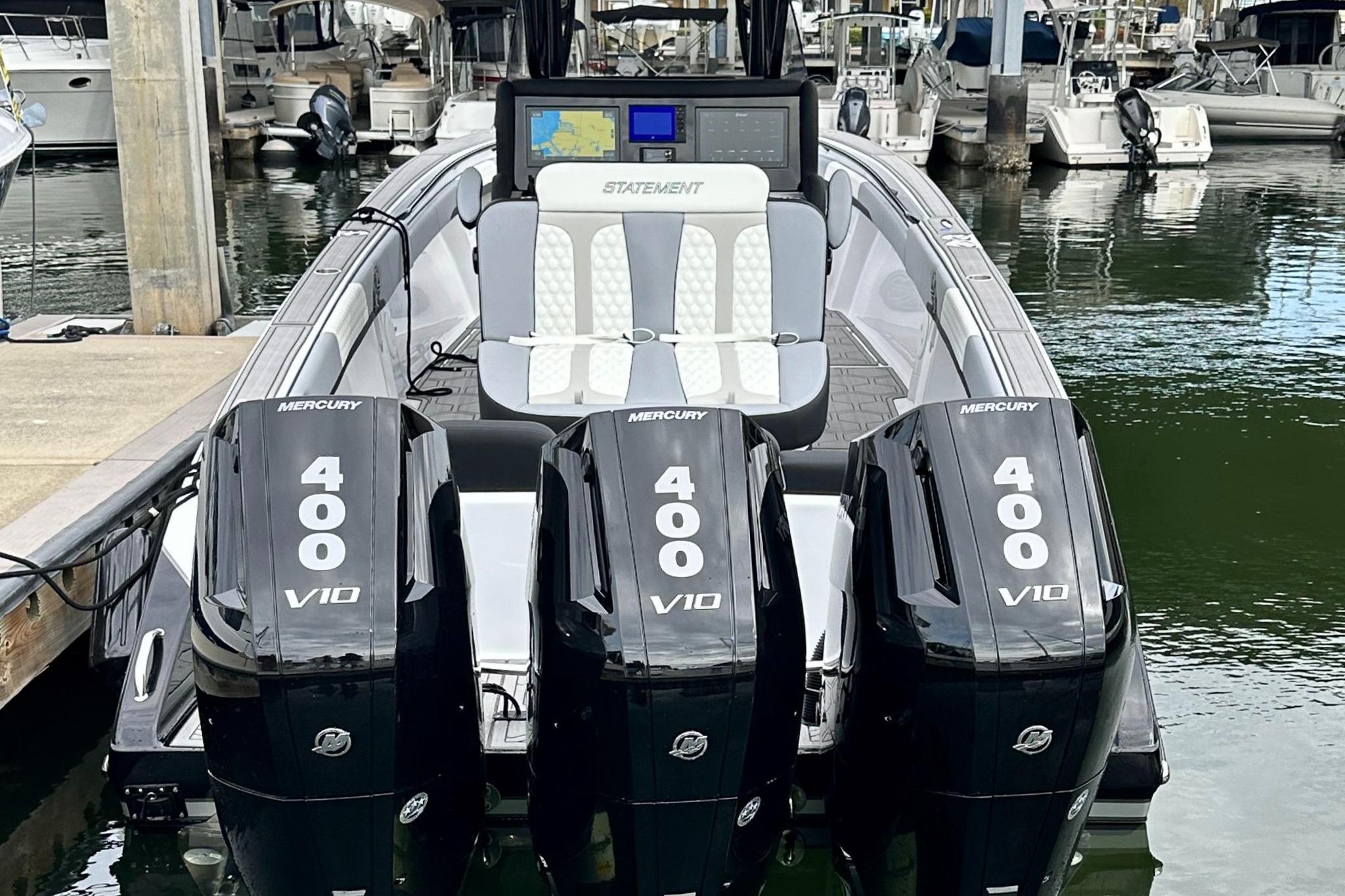 2024 Statement 350 Open boat with triple Mercury 400 V10 engines docked at marina.
