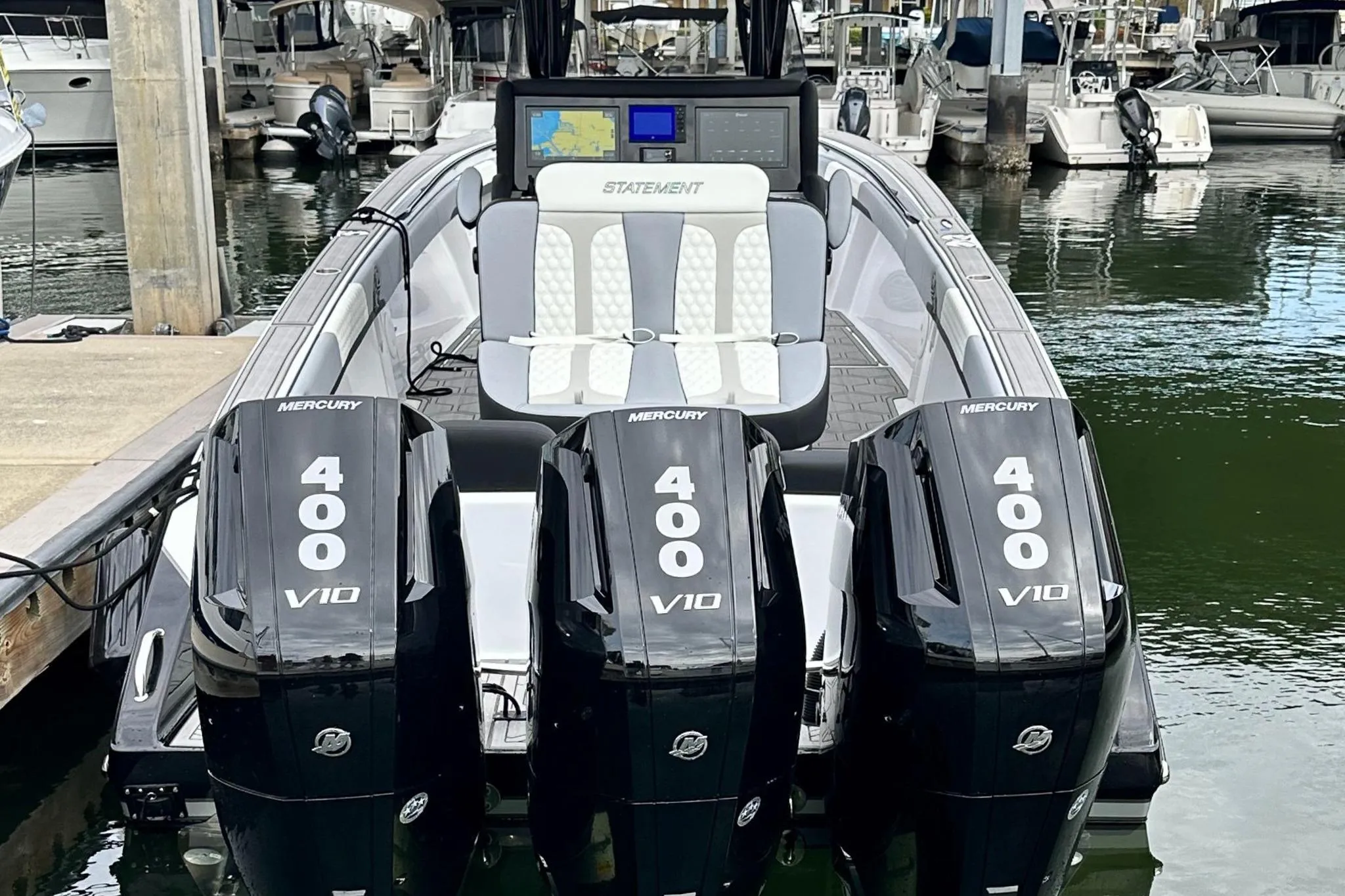 2024 Statement 350 Open boat with triple Mercury 400 V10 engines docked at marina.
