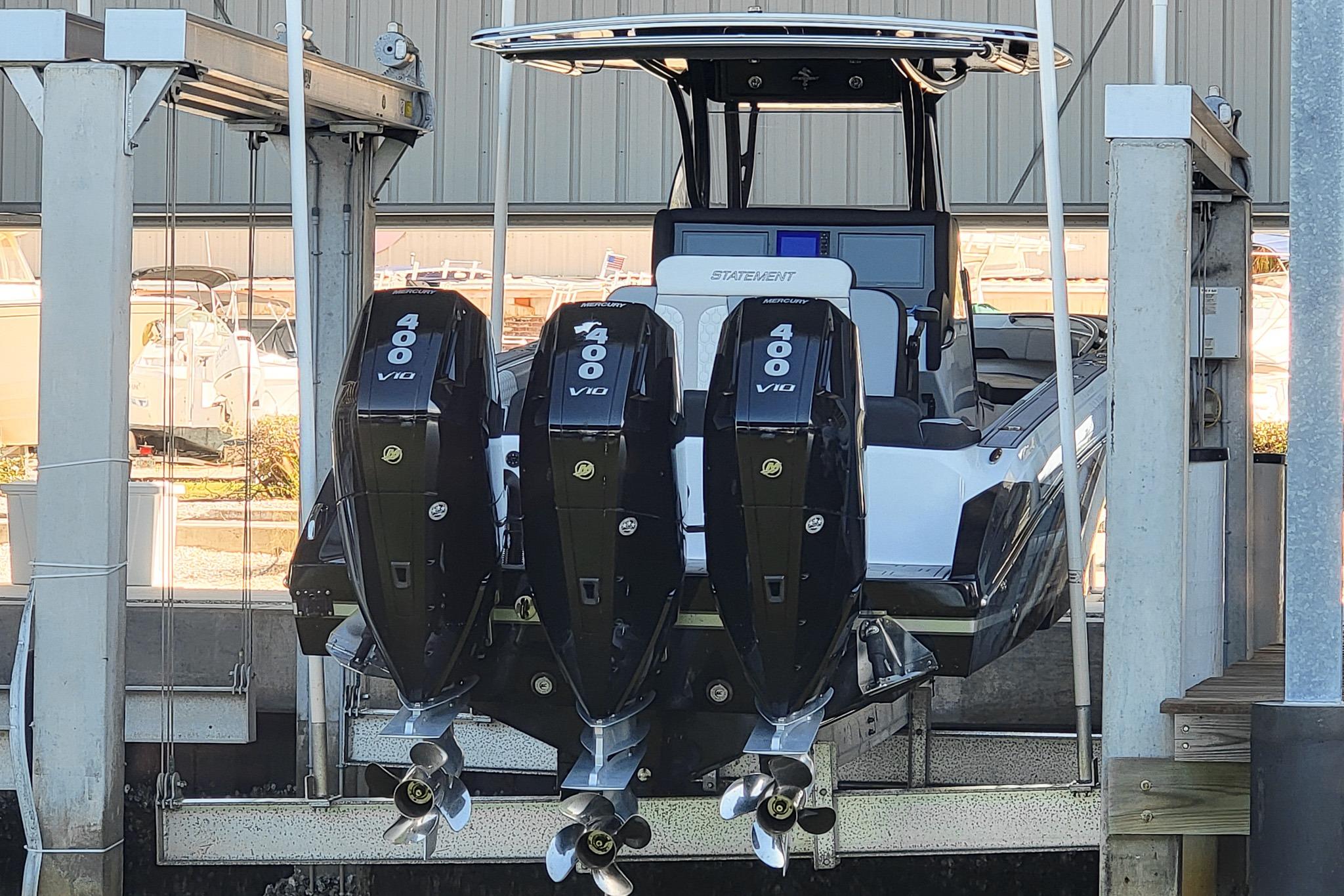 2024 Statement 350 Open boat with triple Mercury 400 V10 engines in a marina lift.