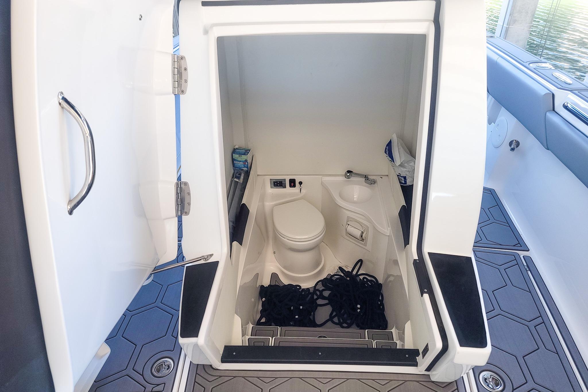 2024 Statement 350 Open boat interior with compact bathroom and storage space.