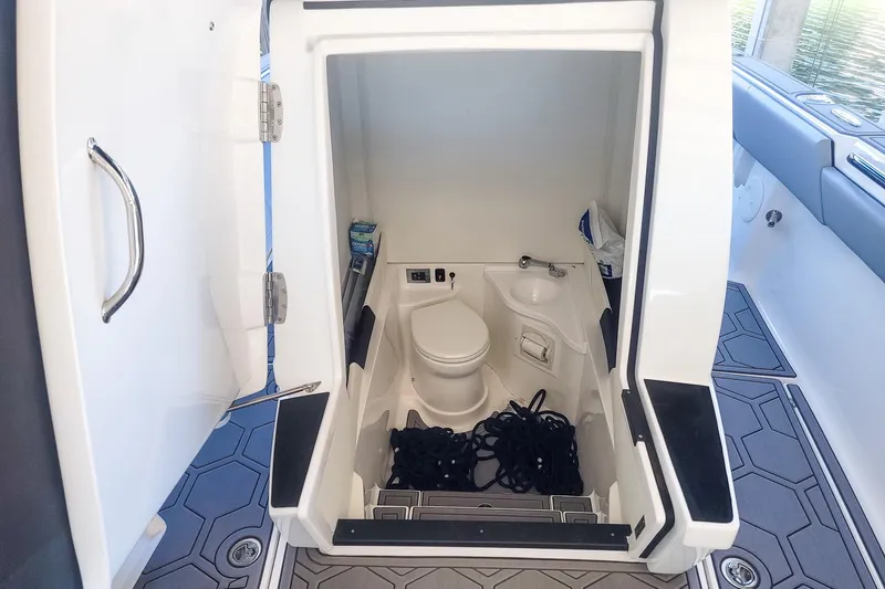  Yacht Photos Pics 2024 Statement 350 Open boat interior with compact bathroom and storage space.