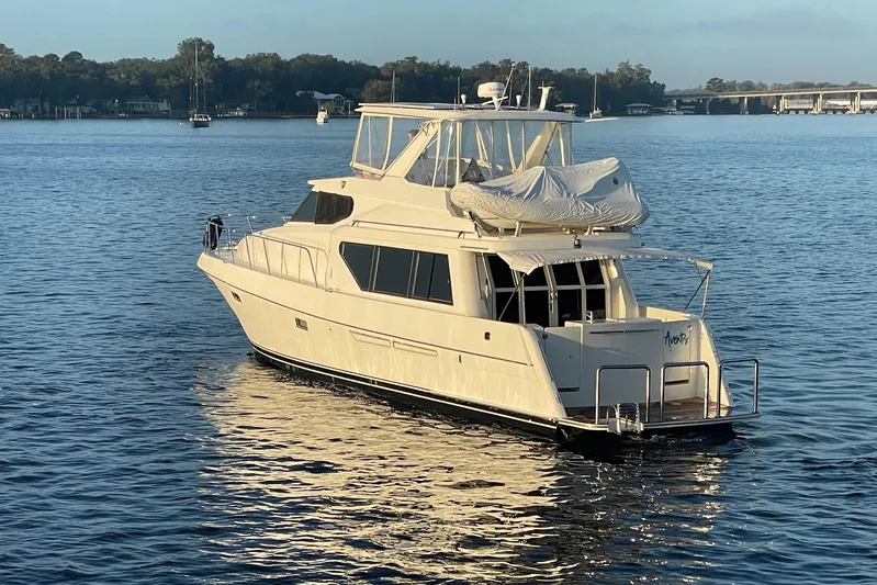 Aventis Yacht Photos Pics 1999 McKinna 57 Pilothouse yacht on calm water, showcasing elegant design and luxury features.
