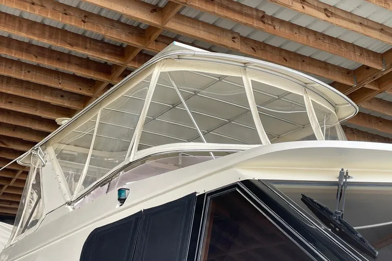 Aventis Yacht Photos Pics 1999 McKinna 57 Pilothouse yacht under wooden roof, showcasing sleek design and windows.