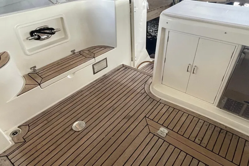 Aventis Yacht Photos Pics 1999 McKinna 57 Pilothouse yacht deck with teak flooring and storage cabinets.