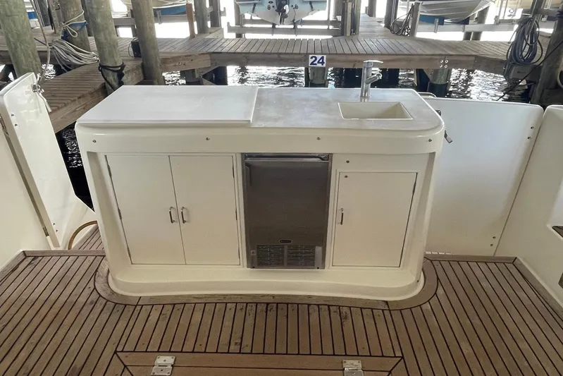 Aventis Yacht Photos Pics Outdoor kitchenette on 1999 McKinna 57 Pilothouse yacht with sink and storage cabinets.