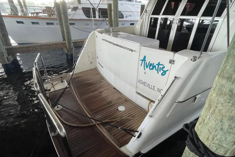 Aventis Yacht Photos Pics 1999 McKinna 57 Pilothouse yacht docked, featuring teak deck and "Aventis" name.