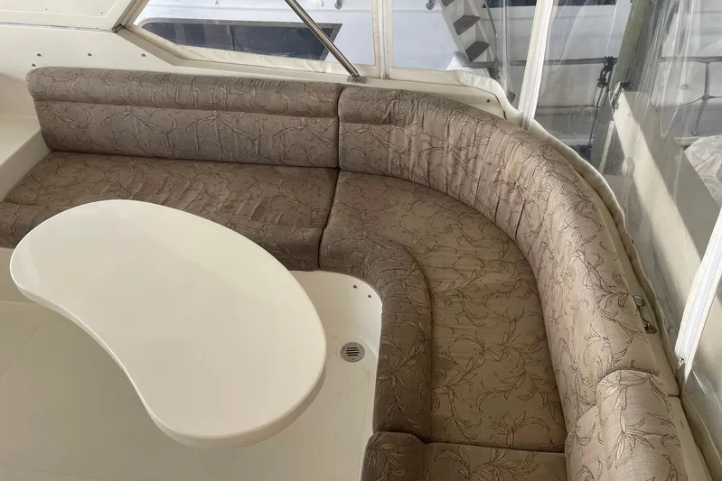 Aventis Yacht Photos Pics 1999 McKinna 57 Pilothouse interior with curved seating and white table.