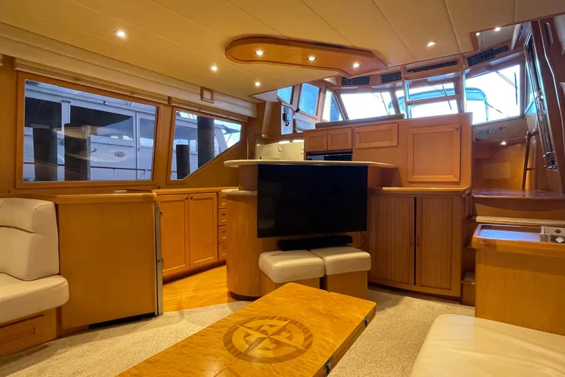 Aventis Yacht Photos Pics Luxurious interior of a 1999 McKinna 57 Pilothouse yacht with wood finishes and modern amenities.