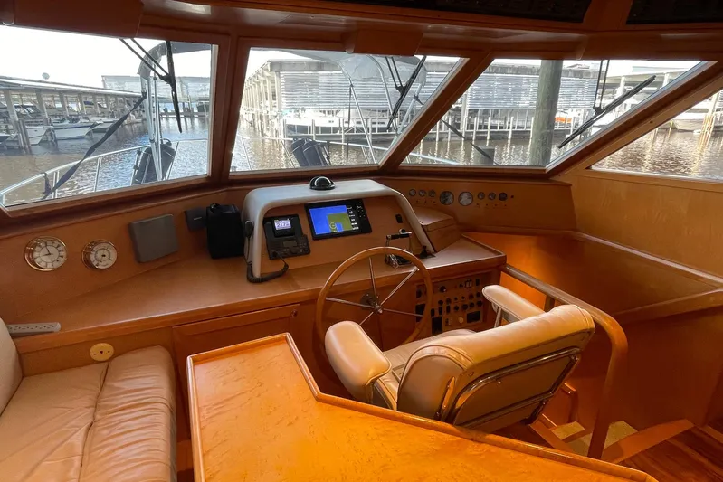 Aventis Yacht Photos Pics 1999 McKinna 57 Pilothouse helm with leather seating and navigation controls.