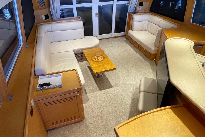 Aventis Yacht Photos Pics Luxurious interior of a 1999 McKinna 57 Pilothouse yacht with elegant seating and wooden accents.