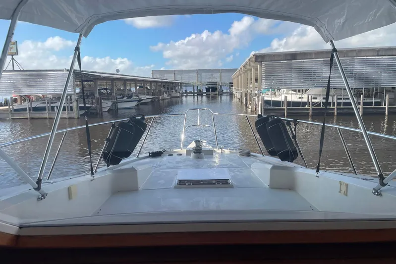 Aventis Yacht Photos Pics 1999 McKinna 57 Pilothouse yacht docked at marina under clear blue sky.