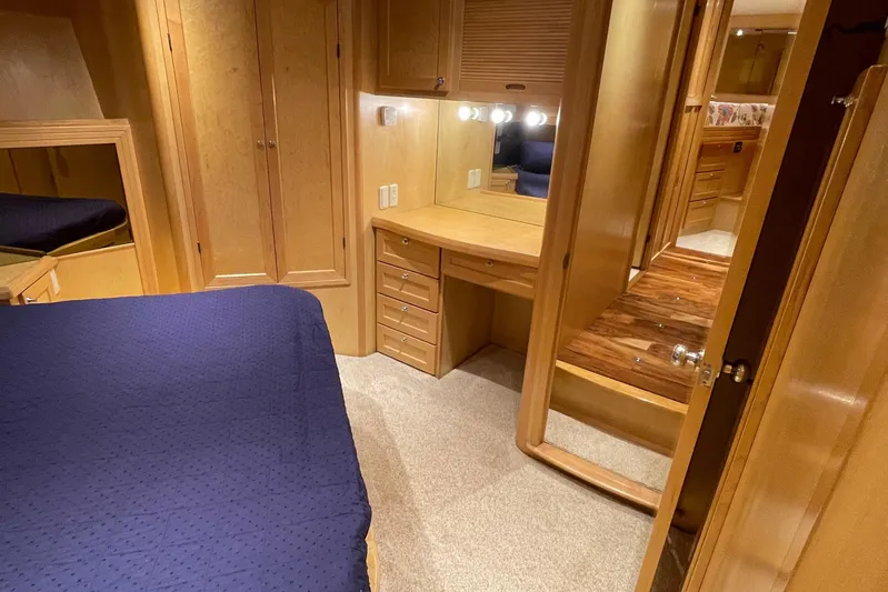 Aventis Yacht Photos Pics 1999 McKinna 57 Pilothouse interior with wooden cabinetry, blue bedding, and vanity area.