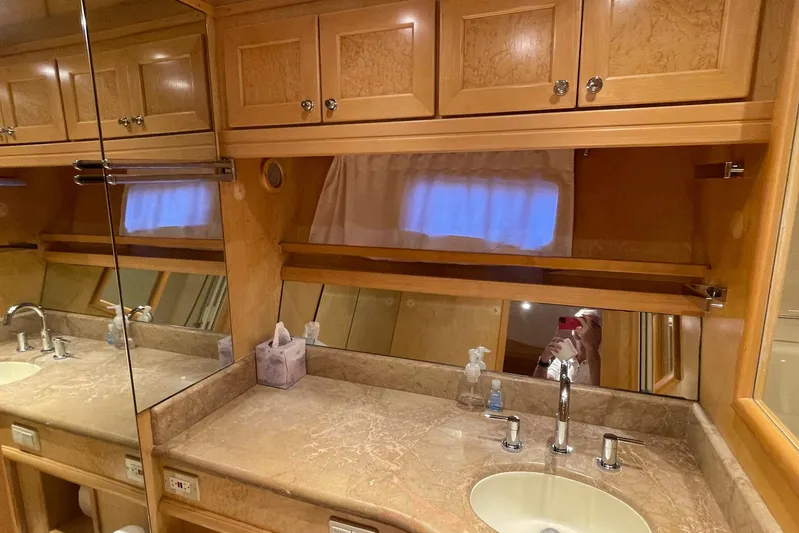Aventis Yacht Photos Pics Luxurious bathroom interior of 1999 McKinna 57 Pilothouse yacht with wooden cabinetry.