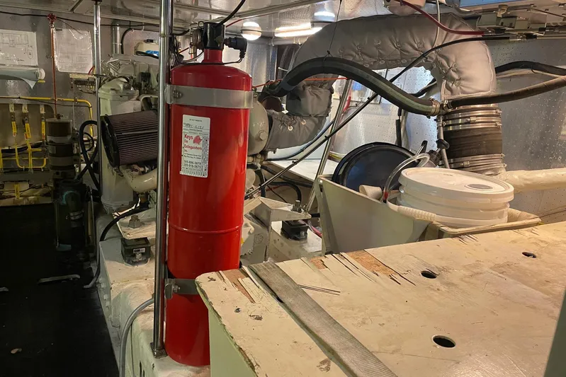 Aventis Yacht Photos Pics Engine room of 1999 McKinna 57 Pilothouse with fire extinguisher and mechanical components.