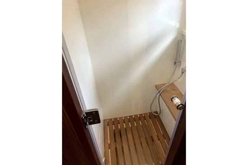  Yacht Photos Pics Shower area in 2020 Cayman Yachts S520 with wooden floor and handheld showerhead.