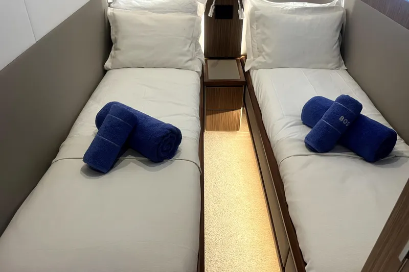  Yacht Photos Pics Luxurious twin cabin in 2020 Cayman Yachts S520 with plush bedding and blue towels.