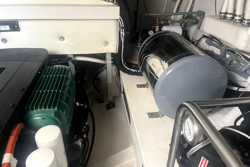  Yacht Photos Pics Engine room of 2020 Cayman Yachts S520, showcasing mechanical components and wiring.