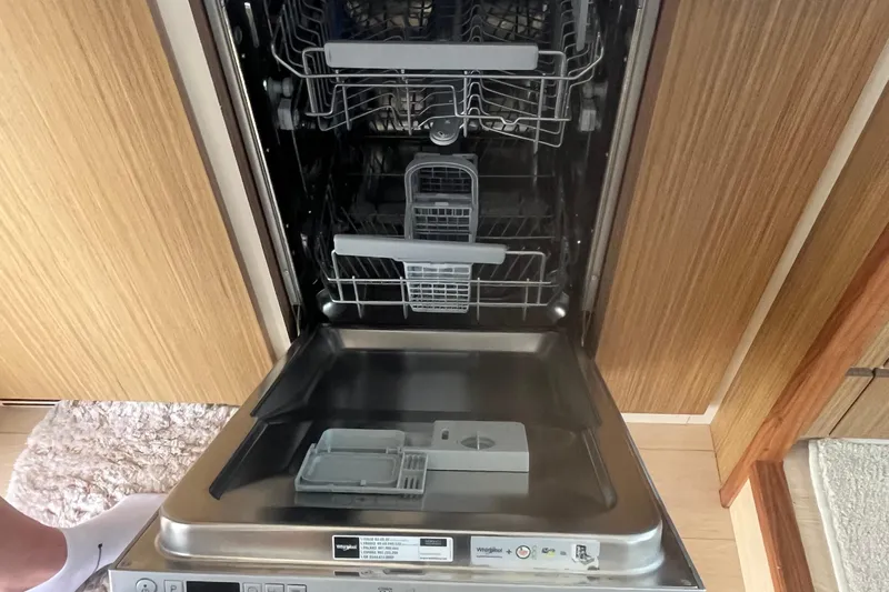  Yacht Photos Pics Open dishwasher inside a 2020 Cayman Yachts S520, showcasing interior racks and controls.