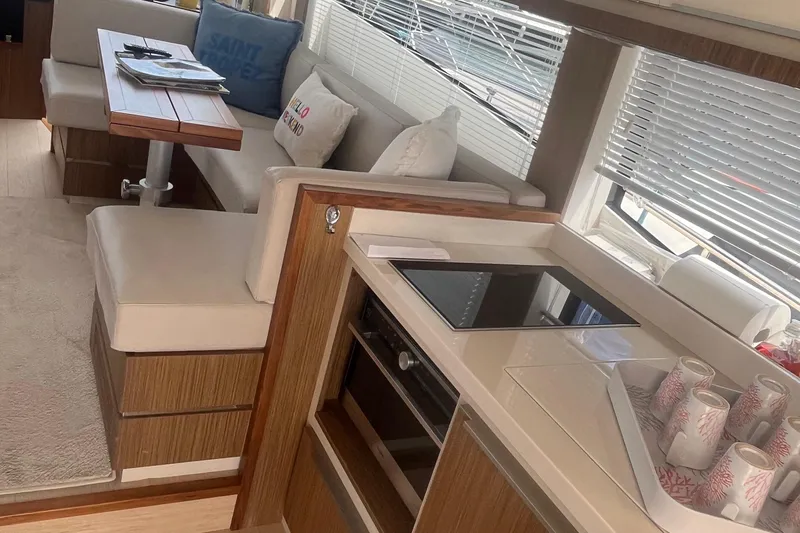  Yacht Photos Pics Luxurious interior of 2020 Cayman Yachts S520 with modern kitchen and cozy seating area.