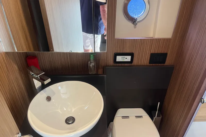  Yacht Photos Pics Luxurious bathroom in 2020 Cayman Yachts S520, featuring modern sink and porthole window.