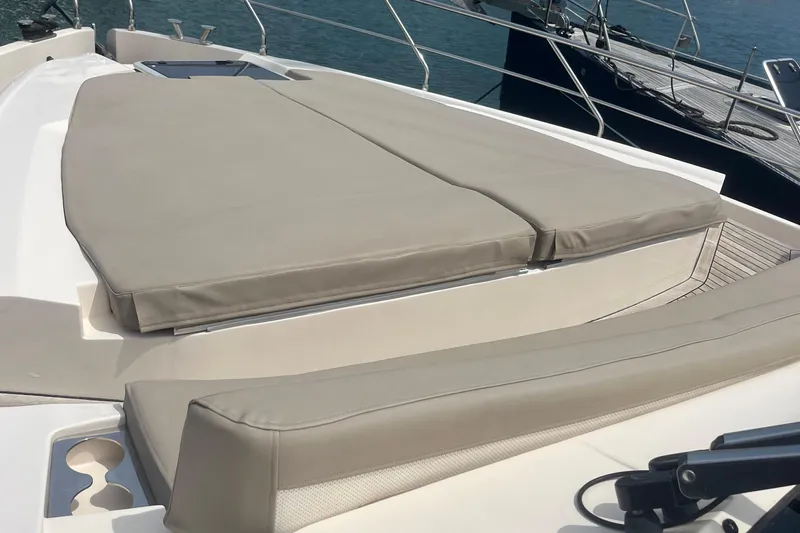  Yacht Photos Pics Luxury sunbathing area on 2020 Cayman Yachts S520, featuring comfortable beige cushions.