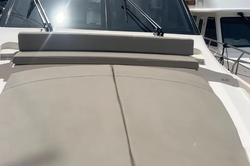  Yacht Photos Pics 2020 Cayman Yachts S520 sun deck with cushioned seating and sleek design.