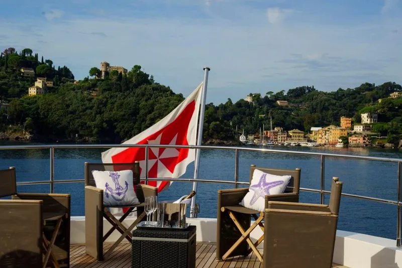 Don Ciro Yacht Photos Pics Deck view from 2002 Benetti Sail Division 105 yacht, overlooking scenic coastal landscape.