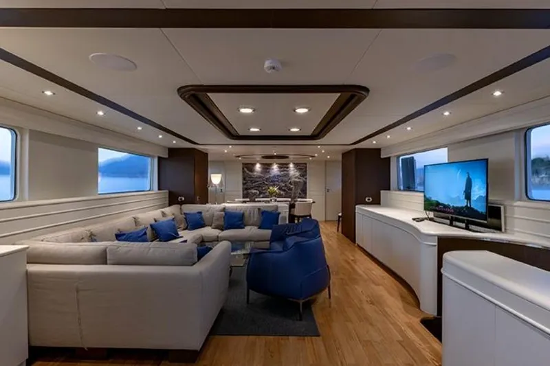 Don Ciro Yacht Photos Pics Luxurious interior of 2002 Benetti Sail Division 105 yacht with modern furnishings and large windows.