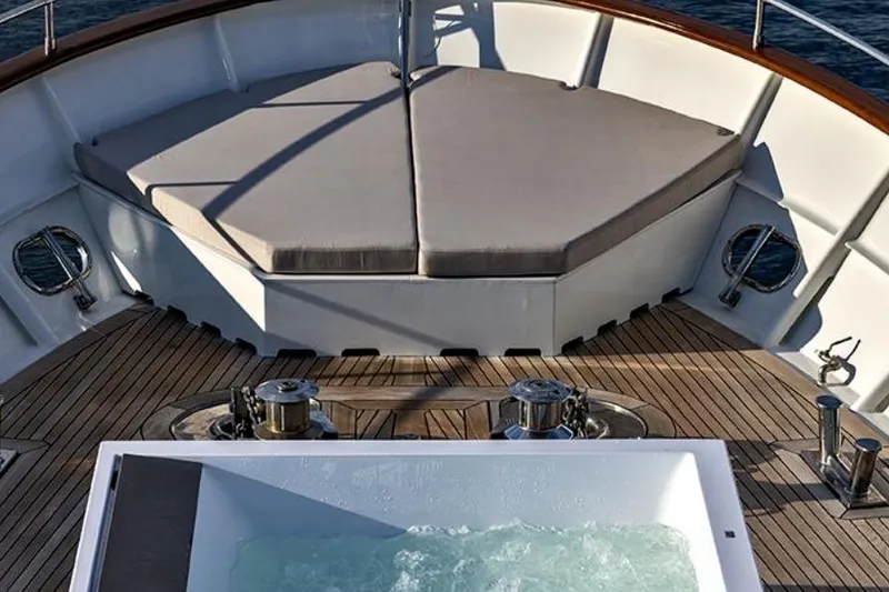 Don Ciro Yacht Photos Pics Luxurious deck of 2002 Benetti Sail Division 105 yacht with jacuzzi and sunbathing area.