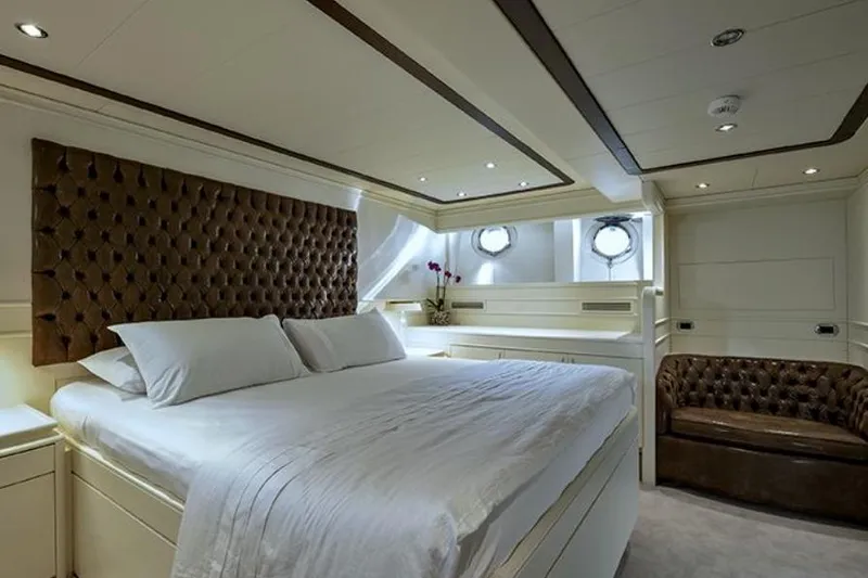 Don Ciro Yacht Photos Pics Luxurious bedroom interior on 2002 Benetti Sail Division 105 yacht, featuring elegant design and plush furnishings.
