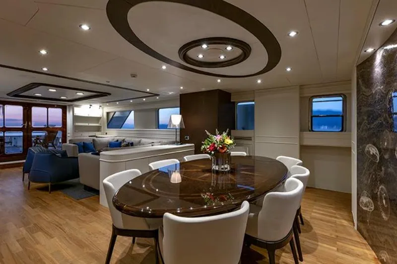 Don Ciro Yacht Photos Pics Luxurious interior of 2002 Benetti Sail Division 105 yacht with elegant dining area.