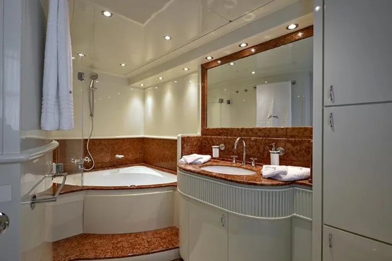 Don Ciro Yacht Photos Pics Luxurious bathroom on 2002 Benetti Sail Division 105 yacht with elegant fixtures and lighting.