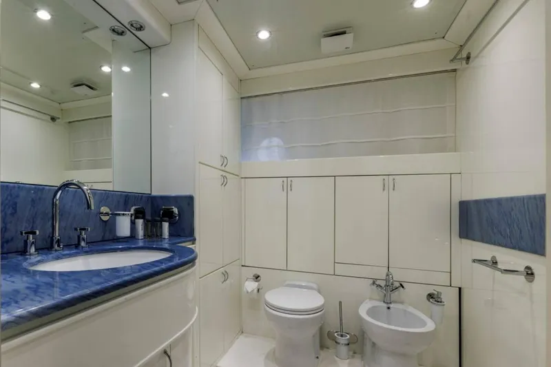 Don Ciro Yacht Photos Pics Luxurious bathroom on 2002 Benetti Sail Division 105 yacht with blue accents and modern fixtures.