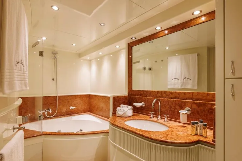 Don Ciro Yacht Photos Pics Luxurious bathroom in 2002 Benetti Sail Division 105 yacht with elegant marble accents.