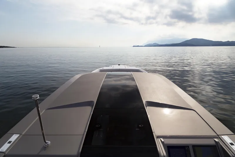  Yacht Photos Pics Front view of 2028 Maori Limo yacht on calm sea with distant mountains.