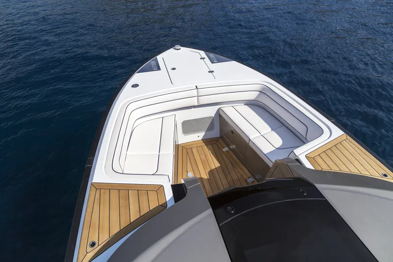  Yacht Photos Pics Luxurious 2028 Maori Limo boat with sleek seating and wooden deck on calm water.