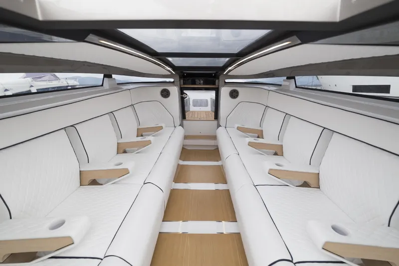  Yacht Photos Pics Luxurious interior of 2028 Maori Limo with white seating and wooden accents.