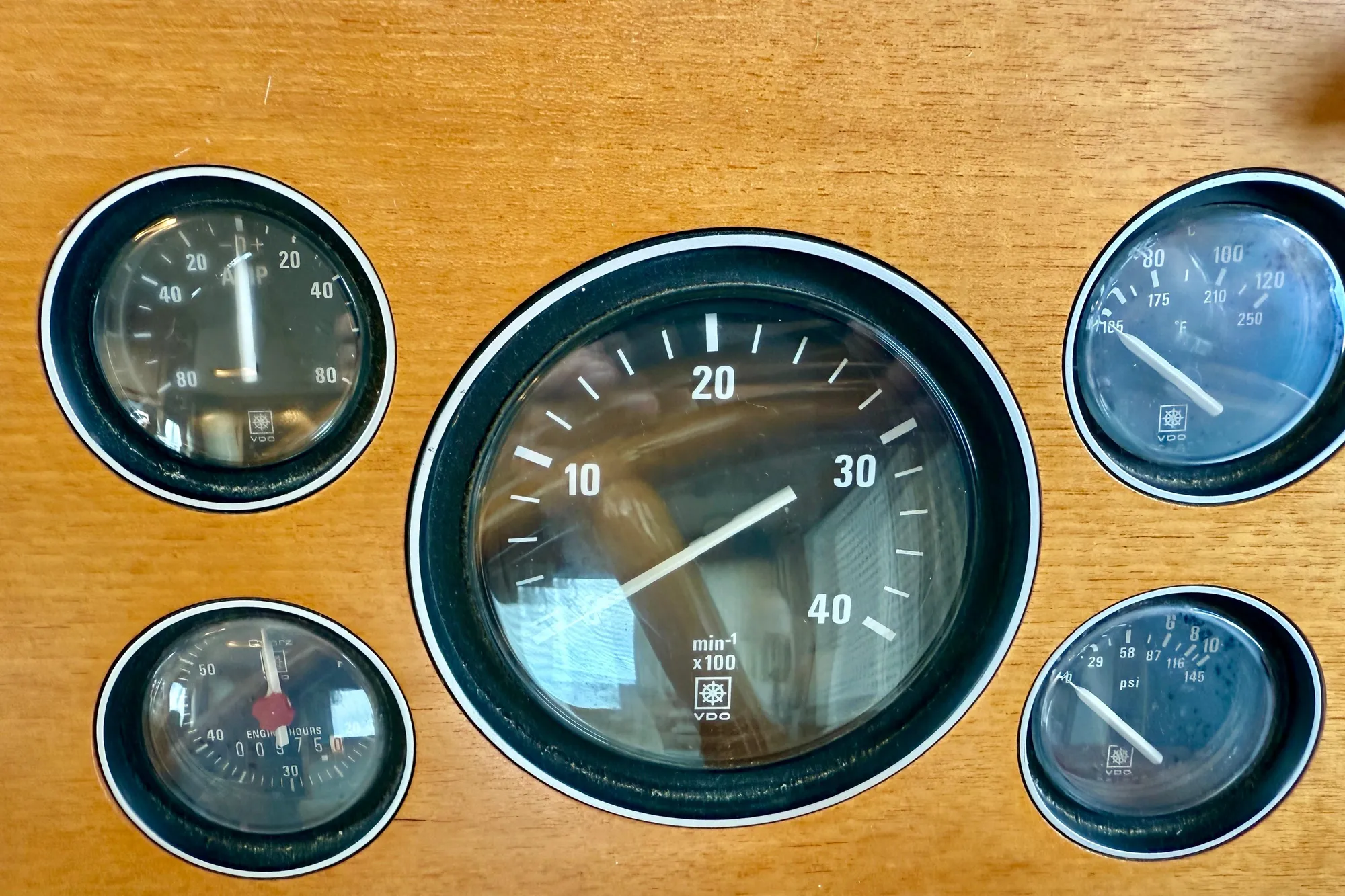 1997 Grand Banks Classic dashboard with five analog gauges on wooden panel.