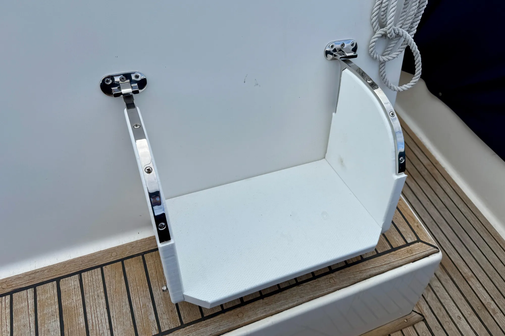 Foldable boat step on a 1997 Grand Banks Classic yacht deck.