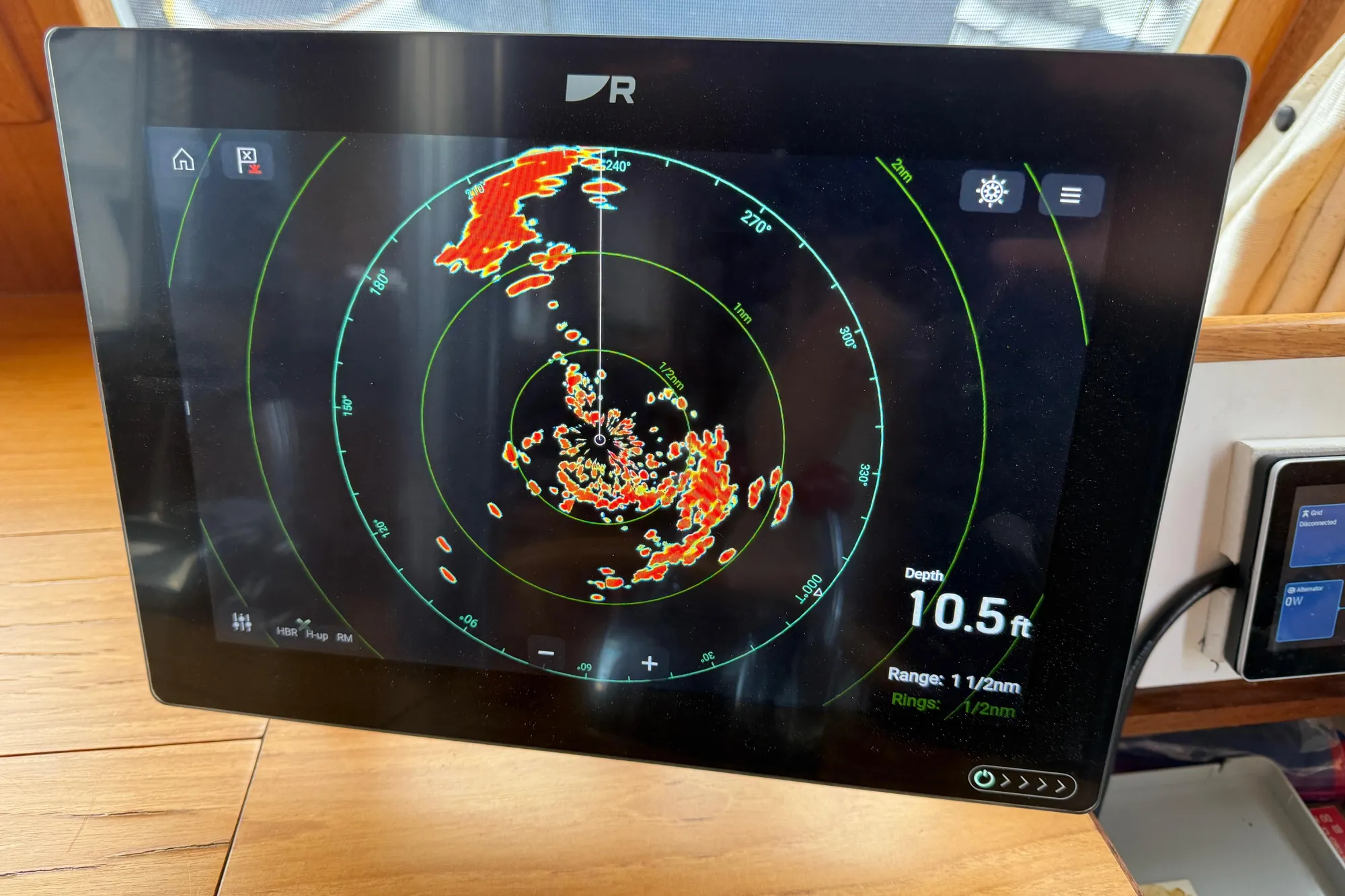 Radar display on 1997 Grand Banks Classic boat showing depth and range data.