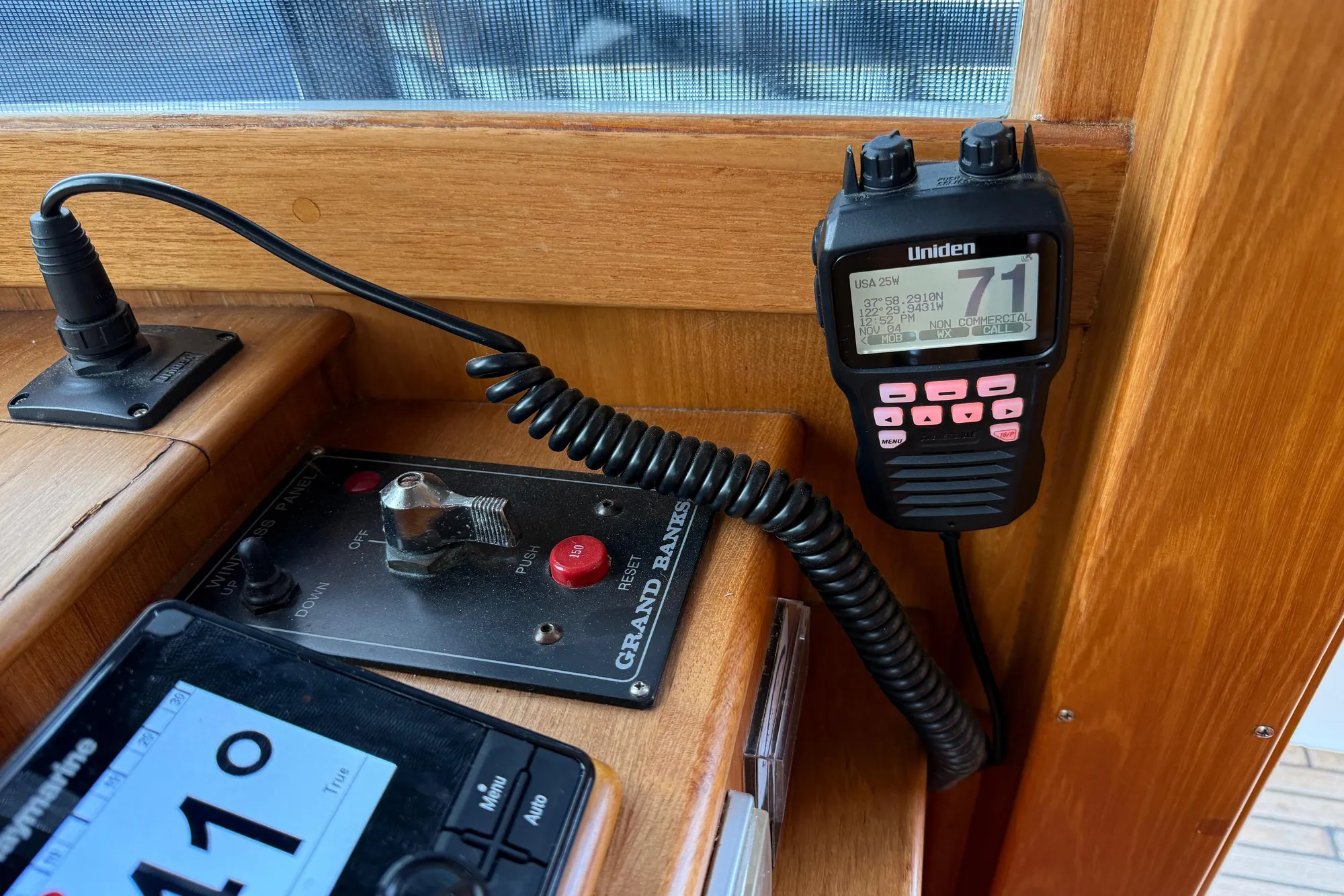 1997 Grand Banks Classic boat dashboard with Uniden radio and control panel.