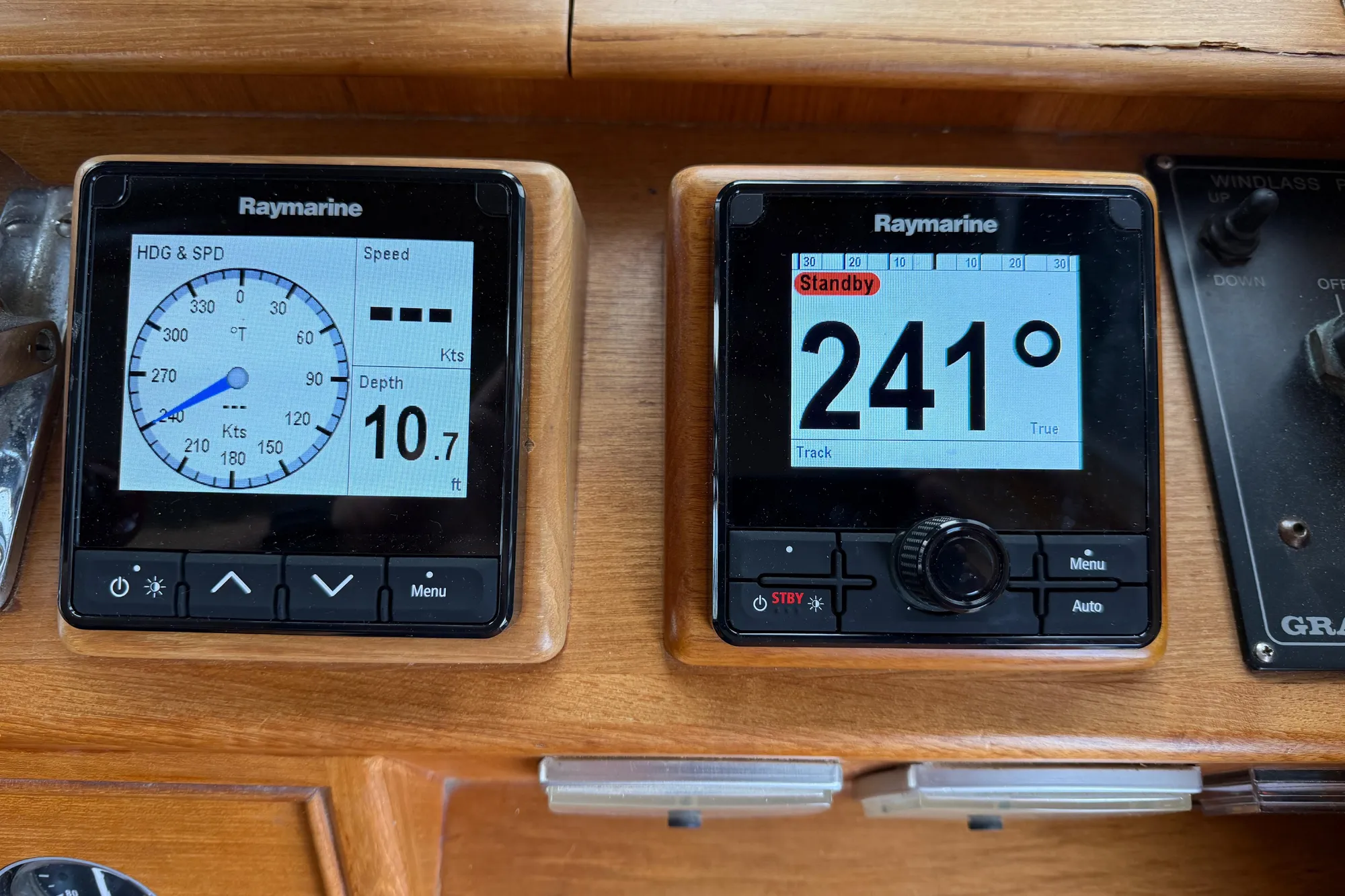 Raymarine navigation displays on 1997 Grand Banks Classic boat dashboard, showing speed and heading.