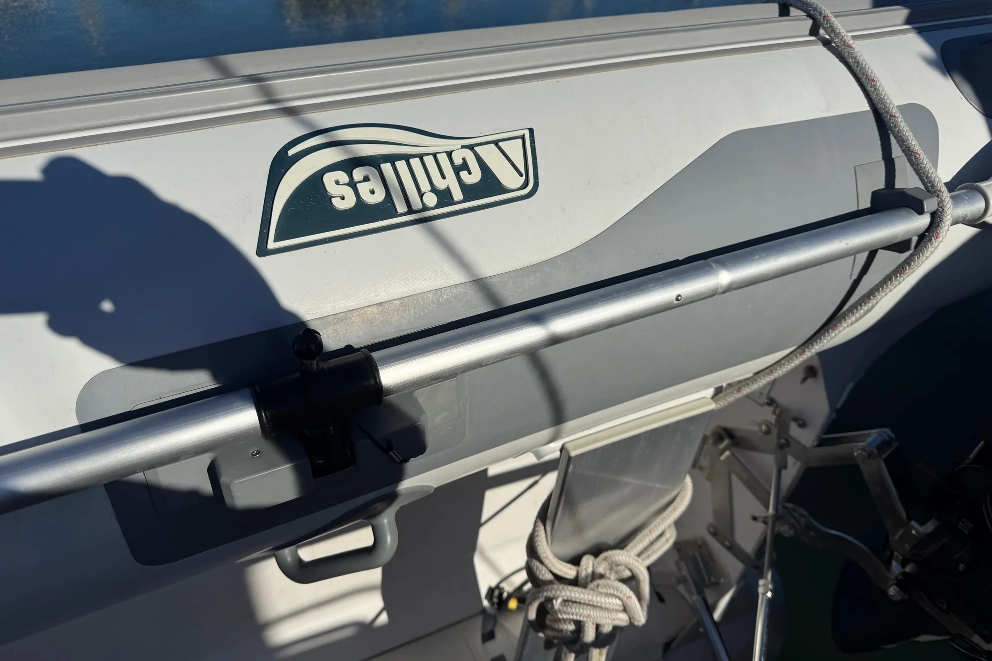 Close-up of a 1997 Grand Banks Classic boat with a dinghy and ropes.